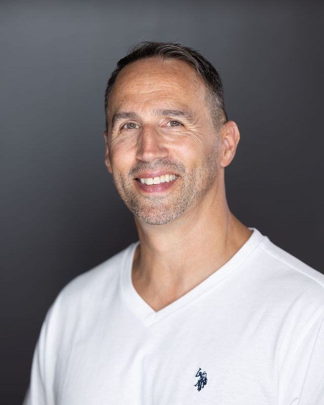 Actor headshot, white tee, dark backdrop