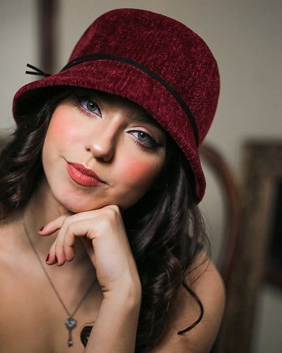Actor headshot, red hat, on location
