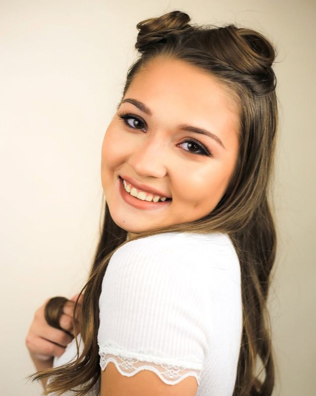 Actor headshot, white top, warm backdrop
