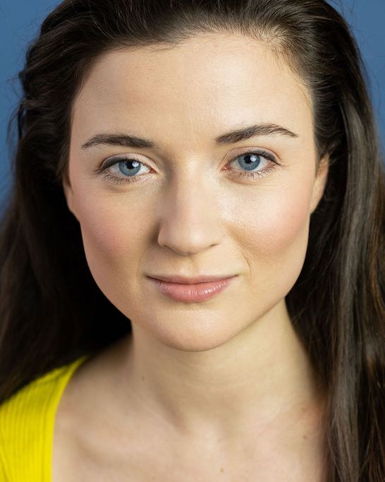 Actor headshot, close crop, blue backdrop